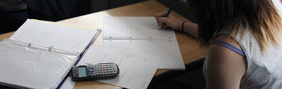 girl doing exam with calculator